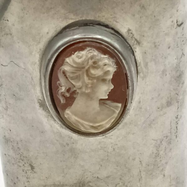 Close up of a cameo mounted on a hip flask